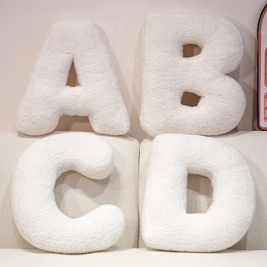 White letter cushions spelling 'ABCD' on a light background