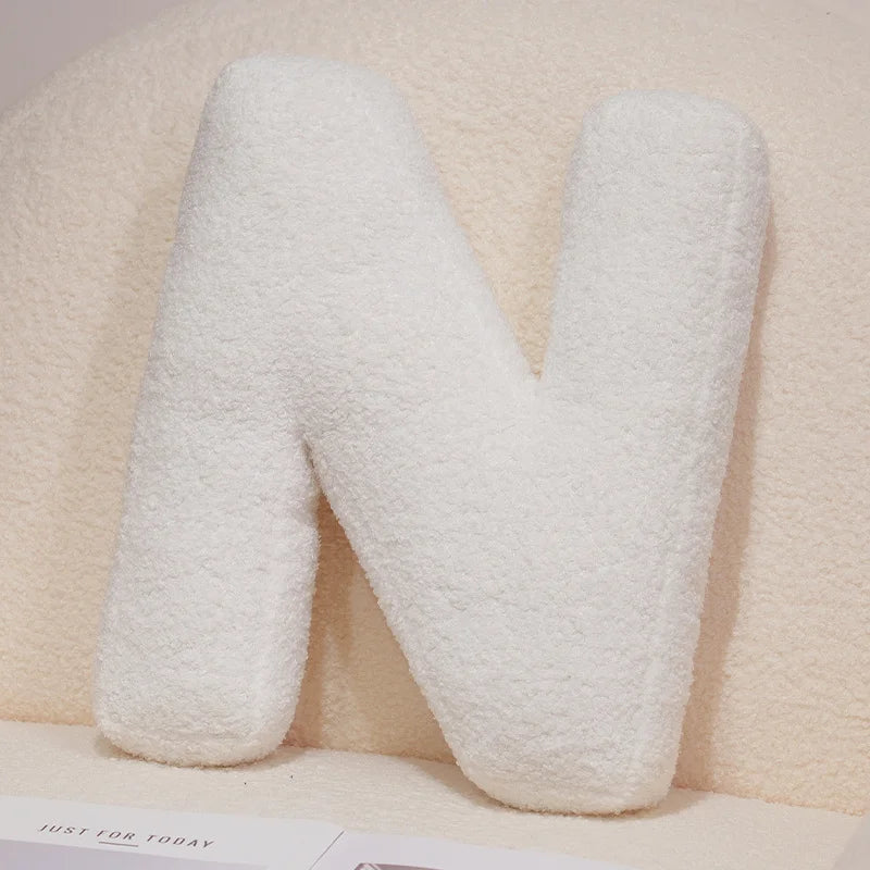 White textured letter 'N' pillow on a light background