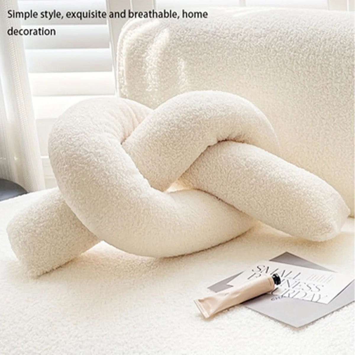 Decorative knot pillow on a surface with a blurred background