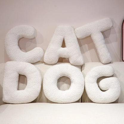 White fluffy letter pillows spelling 'CAT DOG' on a light background