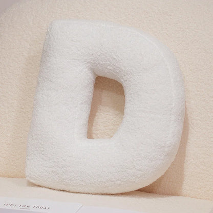 White U-shaped pillow on a beige surface