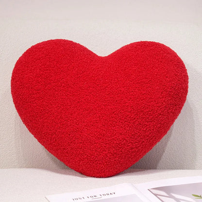 Red heart-shaped pillow on a light background