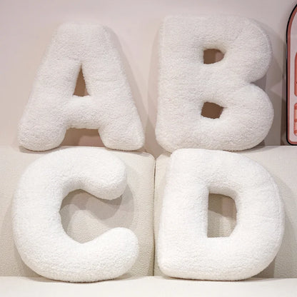 White letter cushions spelling 'ABCD' on a light background